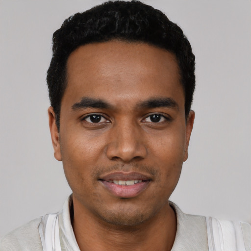 Joyful latino young-adult male with short  black hair and brown eyes