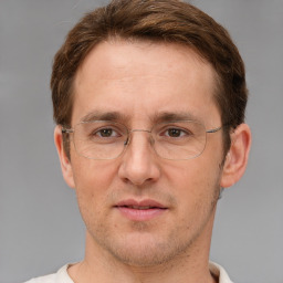 Joyful white adult male with short  brown hair and grey eyes