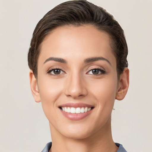 Joyful white young-adult female with short  brown hair and brown eyes