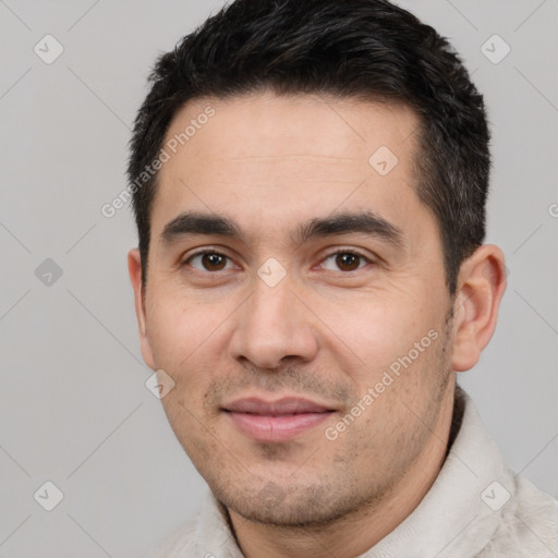 Joyful white young-adult male with short  black hair and brown eyes