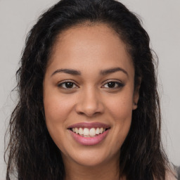 Joyful latino young-adult female with long  brown hair and brown eyes