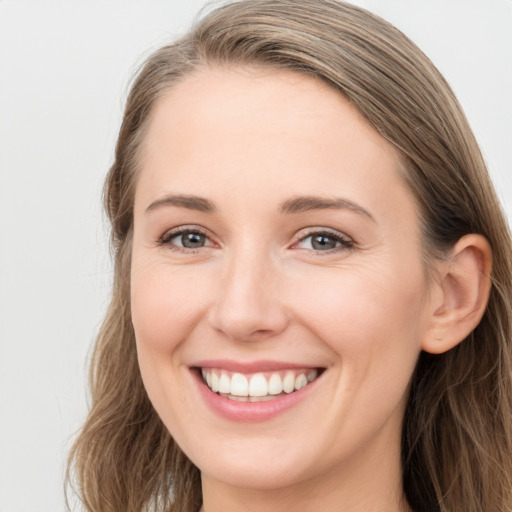 Joyful white young-adult female with long  brown hair and grey eyes