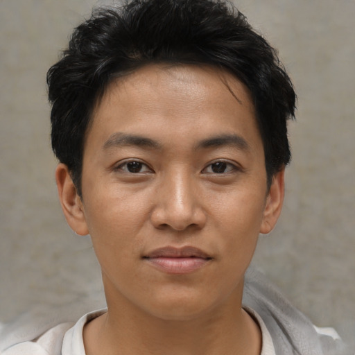 Joyful asian young-adult male with short  black hair and brown eyes