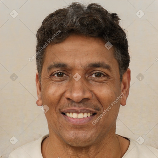 Joyful latino adult male with short  brown hair and brown eyes