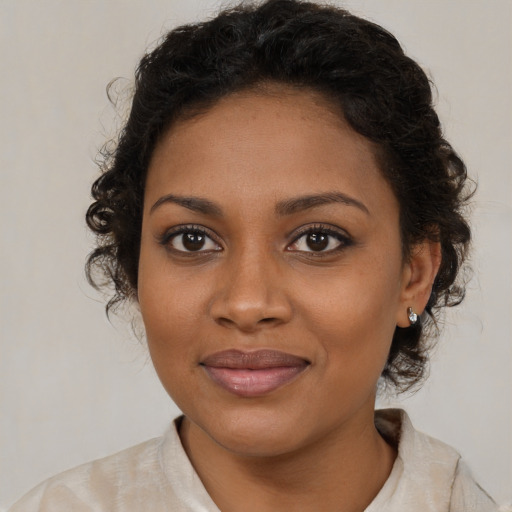 Joyful black young-adult female with medium  brown hair and brown eyes