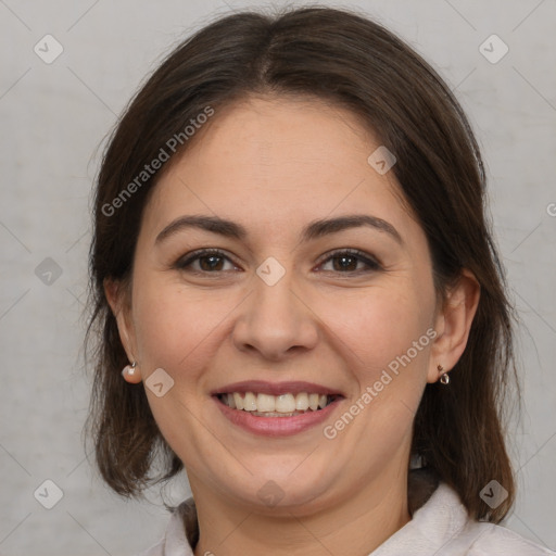 Joyful white adult female with medium  brown hair and brown eyes