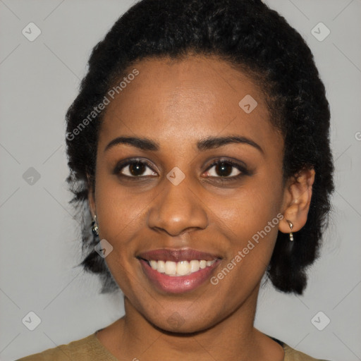 Joyful black young-adult female with short  black hair and brown eyes