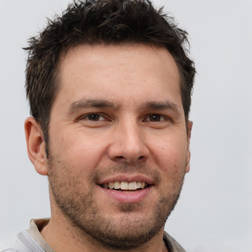 Joyful white young-adult male with short  brown hair and brown eyes