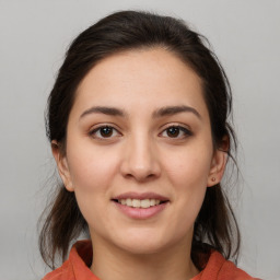 Joyful white young-adult female with medium  brown hair and brown eyes