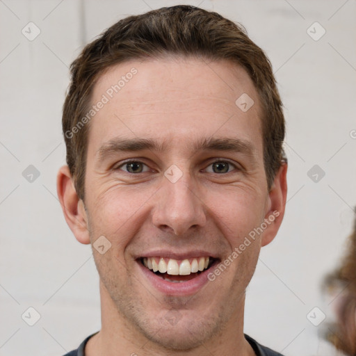 Joyful white young-adult male with short  brown hair and grey eyes