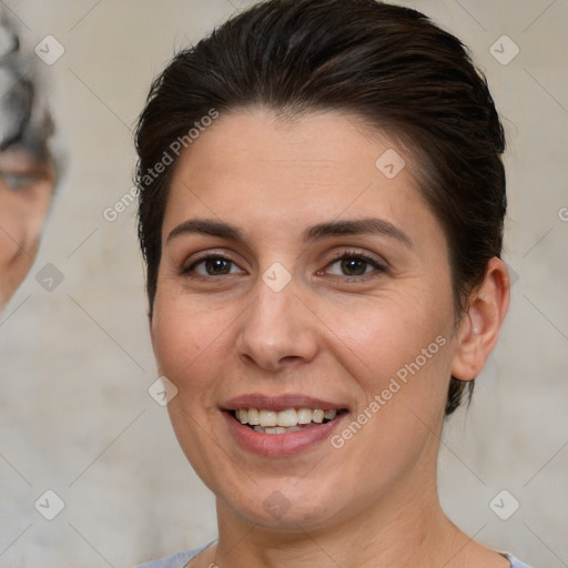 Joyful white adult female with short  brown hair and brown eyes