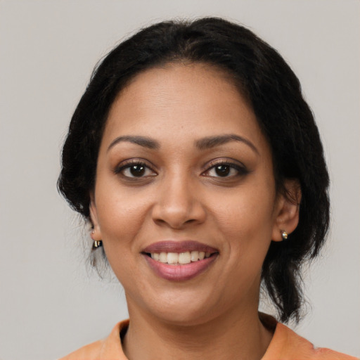 Joyful latino young-adult female with medium  black hair and brown eyes