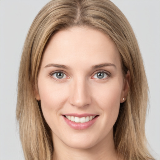 Joyful white young-adult female with long  brown hair and green eyes