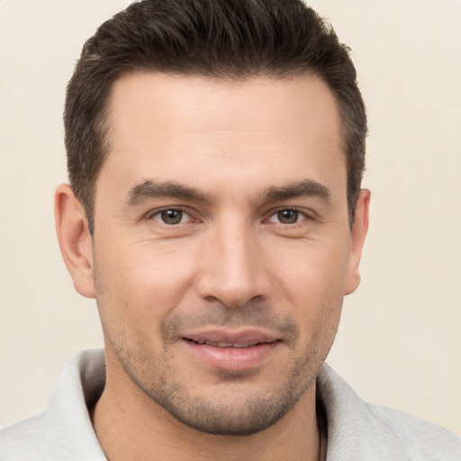 Joyful white young-adult male with short  brown hair and brown eyes