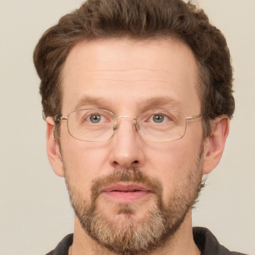 Joyful white adult male with short  brown hair and grey eyes