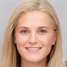 Joyful white young-adult female with long  brown hair and blue eyes