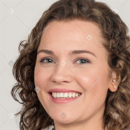 Joyful white young-adult female with medium  brown hair and green eyes