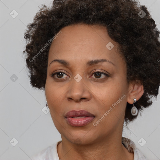 Joyful black adult female with medium  brown hair and brown eyes