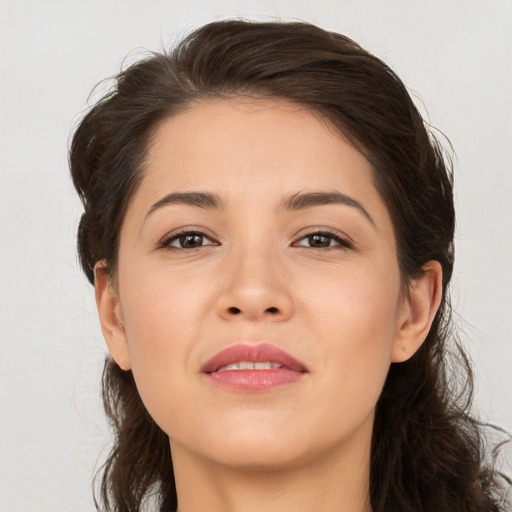 Joyful white young-adult female with long  brown hair and brown eyes