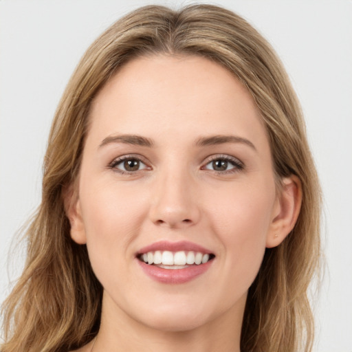 Joyful white young-adult female with long  brown hair and green eyes