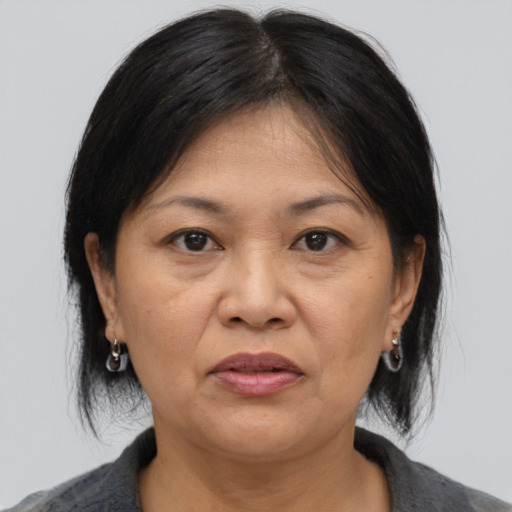 Joyful asian adult female with medium  brown hair and brown eyes