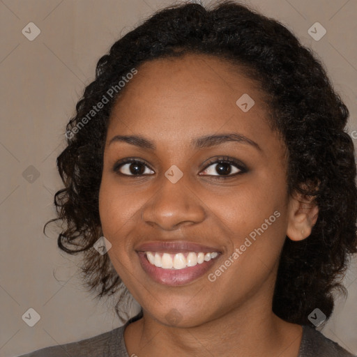 Joyful black young-adult female with medium  black hair and brown eyes