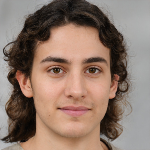 Joyful white young-adult male with medium  brown hair and brown eyes