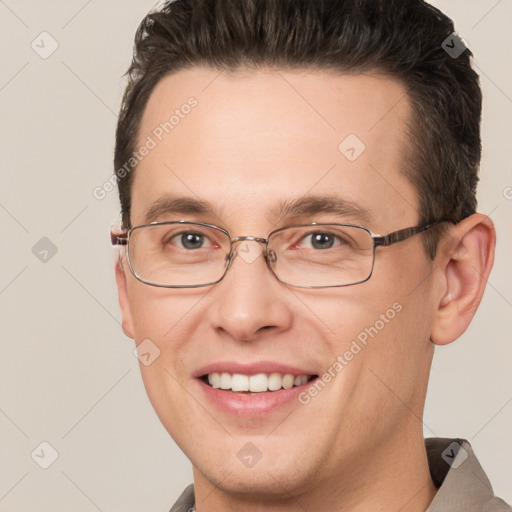 Joyful white adult male with short  brown hair and brown eyes