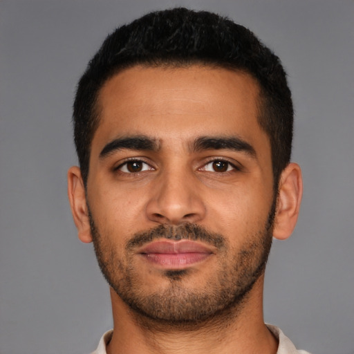 Joyful latino young-adult male with short  brown hair and brown eyes