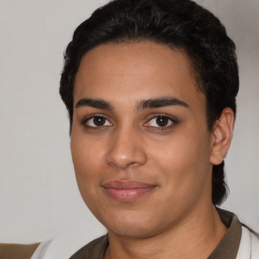 Joyful latino young-adult female with short  black hair and brown eyes