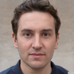 Joyful white adult male with short  brown hair and grey eyes