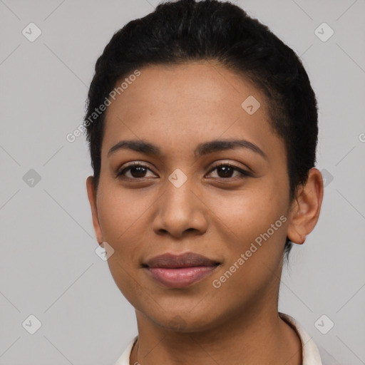 Joyful latino young-adult female with short  black hair and brown eyes