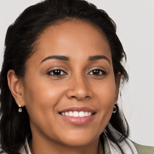 Joyful latino young-adult female with long  brown hair and brown eyes