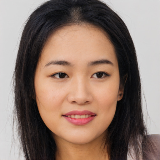 Joyful asian young-adult female with long  brown hair and brown eyes