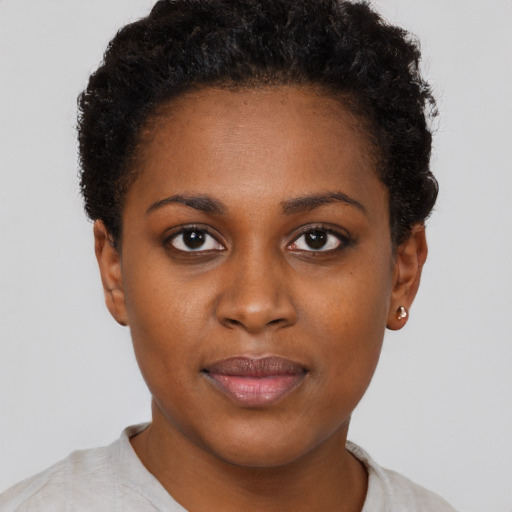 Joyful black young-adult female with short  brown hair and brown eyes