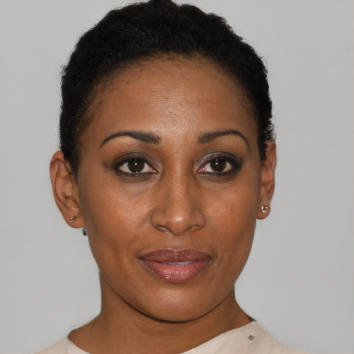 Joyful black young-adult female with short  black hair and brown eyes