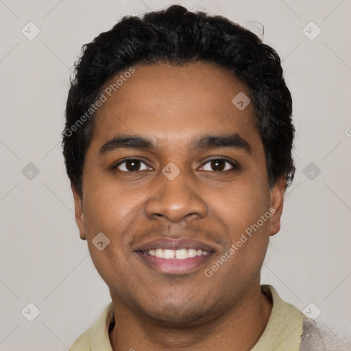 Joyful black young-adult male with short  black hair and brown eyes