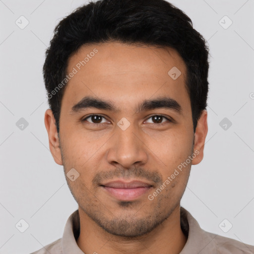 Joyful latino young-adult male with short  black hair and brown eyes