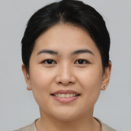 Joyful asian young-adult female with short  brown hair and brown eyes