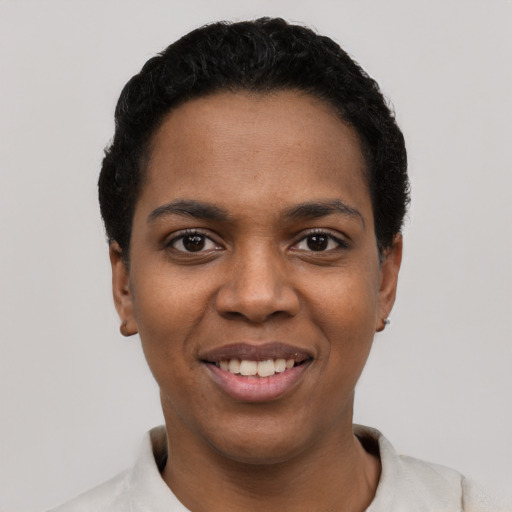 Joyful latino young-adult female with short  black hair and brown eyes