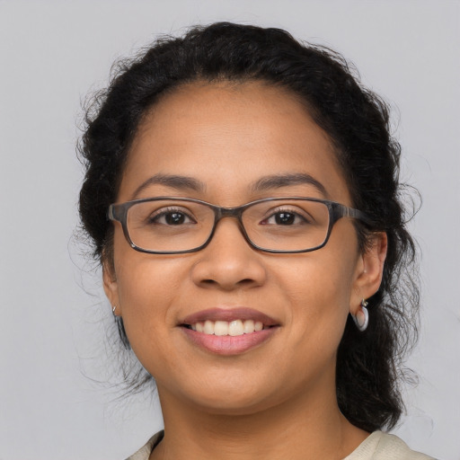 Joyful latino young-adult female with medium  brown hair and brown eyes