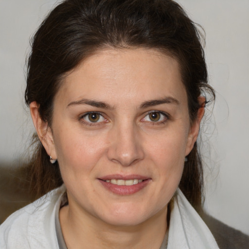 Joyful white adult female with medium  brown hair and brown eyes