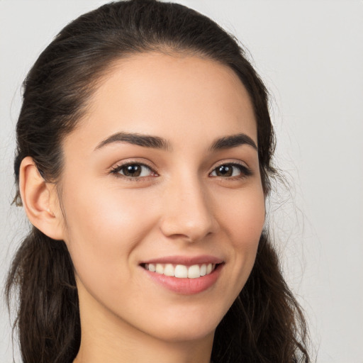 Joyful white young-adult female with long  brown hair and brown eyes