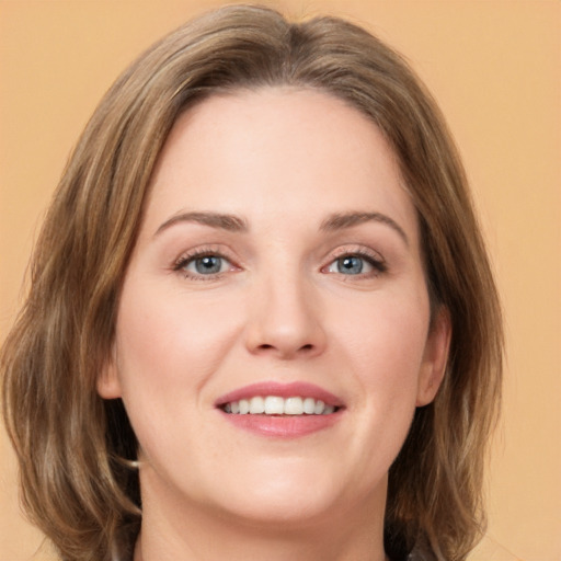 Joyful white young-adult female with medium  brown hair and green eyes