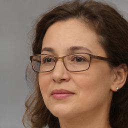 Joyful white adult female with long  brown hair and brown eyes