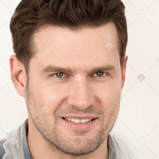 Joyful white adult male with short  brown hair and grey eyes