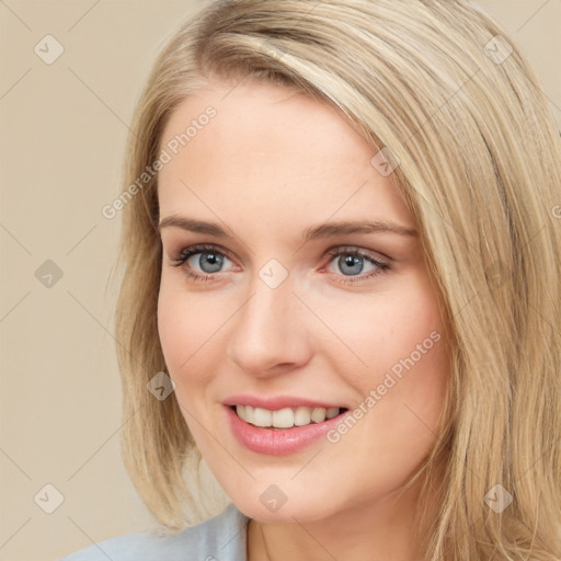 Joyful white young-adult female with long  brown hair and blue eyes