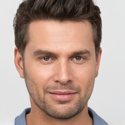 Joyful white young-adult male with short  brown hair and brown eyes