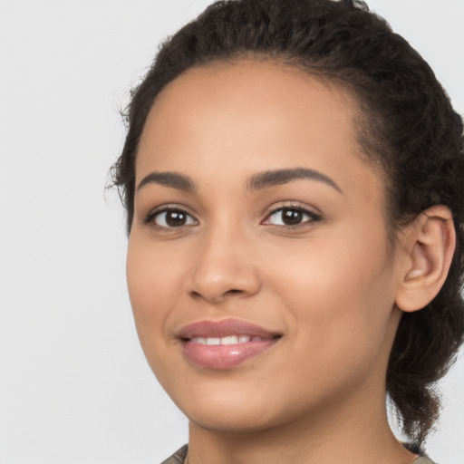 Joyful latino young-adult female with long  brown hair and brown eyes