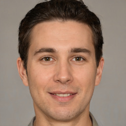 Joyful white adult male with short  brown hair and brown eyes